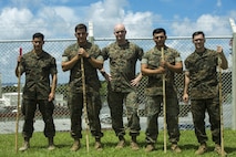 U.S. Marine Cpls. Otto Thiele (center left), Eric Goodman (center), and Christopher Ehms (far right) and Lance Cpls. Antonio Martinez (far left) and Avelardo Guevera Osuna (center right) came together to assist a local Japanese woman during their hike on Mount Fuji, Japan, July 3, 2017. The woman, Oda Moe, was found lying on the ground, hyperventilating and struggling to breathe when the Marines came to her assistance. Together, they created a makeshift stretcher to carry her down approximately two miles to get to medical assistance. The Marines are with Electronics Maintenance Company, 3d Maintenance Battalion, Combat Logistics Regiment 35, 3d Marine Logistics Group, III Marine Expeditionary Force.