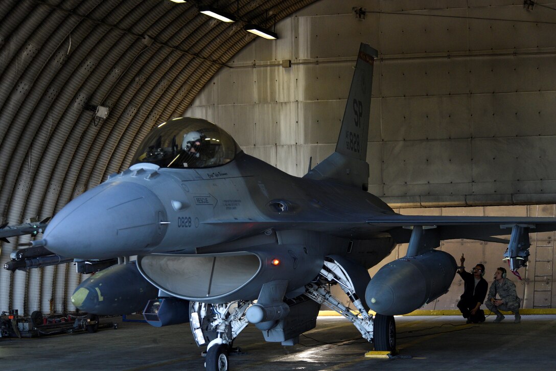 Cadet 2nd Class Garrett Amy, right, shadows Airman 1st Class Joshua Leemon, left, 480th Aircraft Maintenance Unit crew chief, while prepping an F-16 Fighting Falcon to taxi at Spangdahlem Air Base, Germany, July 5, 2017. The cadets visited several different squadrons around base to help give them a better understanding of the operational Air Force and help them decide on career paths available to them. (U.S. Air Force photo by Staff Sgt. Jonathan Snyder)