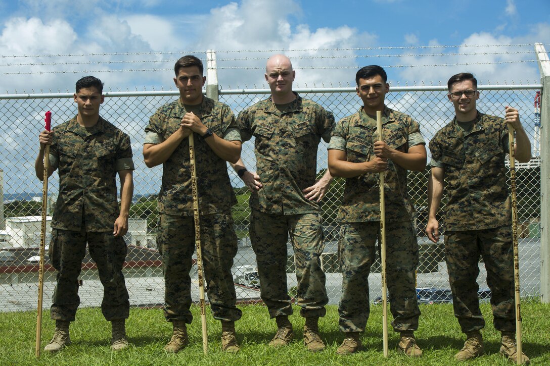U.S. Marine Cpls. Otto Thiele (center left), Eric Goodman (center), and Christopher Ehms (far right) and Lance Cpls. Antonio Martinez (far left) and Avelardo Guevara Osuna (center right) came together to assist a local Japanese woman during their hike on Mount Fuji, Japan, July 3, 2017. The woman, Oda Moe, was found lying on the ground, hyperventilating and struggling to breathe when the Marines came to her assistance. Together, they created a makeshift stretcher to carry her down approximately two miles to get to medical assistance. The Marines are with Electronics Maintenance Company, 3d Maintenance Battalion, Combat Logistics Regiment 35, 3d Marine Logistics Group, III Marine Expeditionary Force.