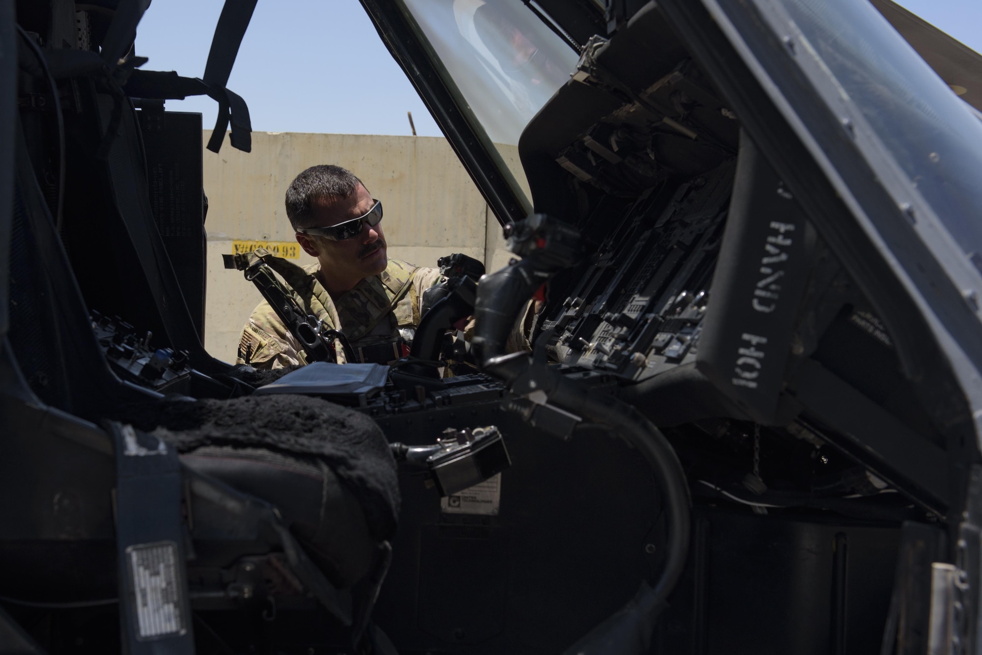 Maj. Paul Brighton checks the inside of an HH-60G Pave Hawk during crew changeover on Bagram Airfield, Afghanistan, July 4, 2017. Brighton is a pilot with the 83rd Expeditionary Rescue Squadron; he is deployed out of Davis-Monthan Air Force Base, Arizona. (U.S. Air Force photo by Staff Sgt. Benjamin Gonsier) 