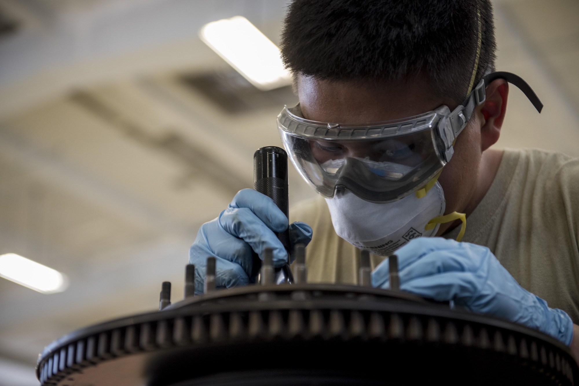 U.S. Air Force Senior Airman Jimmy Thompson, 18th Component Maintenance Squadron aerospace propulsion craftsman, inspects the forward cooling plate of a TF-34 engine July 6, 2017, at Kadena Air Base, Japan. The 18th CMS provides engine maintenance services for various Kadena airframes as well as A-10 Thunderbolt II aircraft from the 51st Fighter Wing, Osan AB, Republic of Korea.