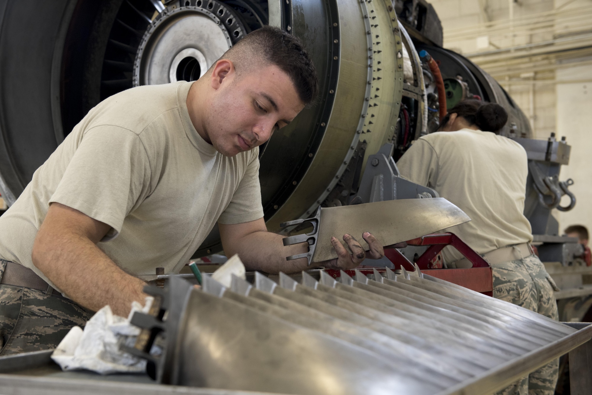 U.S. Air Force Senior Airman Steven Valencia, 18th Component Maintenance Squadron aerospace propulsion journeyman, cleans and inspects fan blades of a TF-34 engine July 6, 2017, at Kadena Air Base, Japan. The fan blades are used to generate approximately 85 percent of the thrust used by A-10 Thunderbolt II aircraft. (U.S. Air Force photo by Senior Airman John Linzmeier)