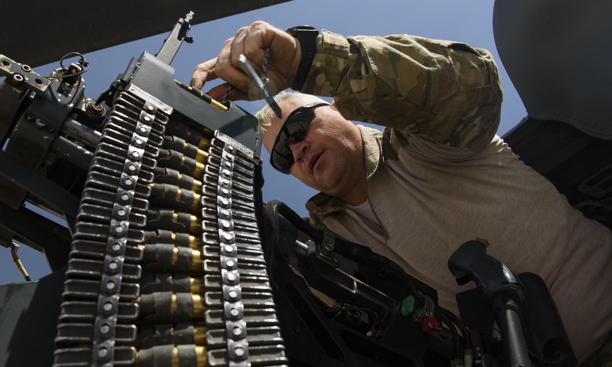 Tech. Sgt. Wayne Cowen, an 83rd Expeditionary Rescue Squadron special missions aviator, loads ammunition into a .50 caliber machine gun on Bagram Airfield, Afghanistan, July 4, 2017. As a special missions aviator, Cowen is a jack-of-all-trades; he conducts pre-flight inspections, maintains the aircraft systems while airborne and employs the aircraft weapons systems in the event of an attack. (U.S. Air Force photo by Staff Sgt. Benjamin Gonsier) 