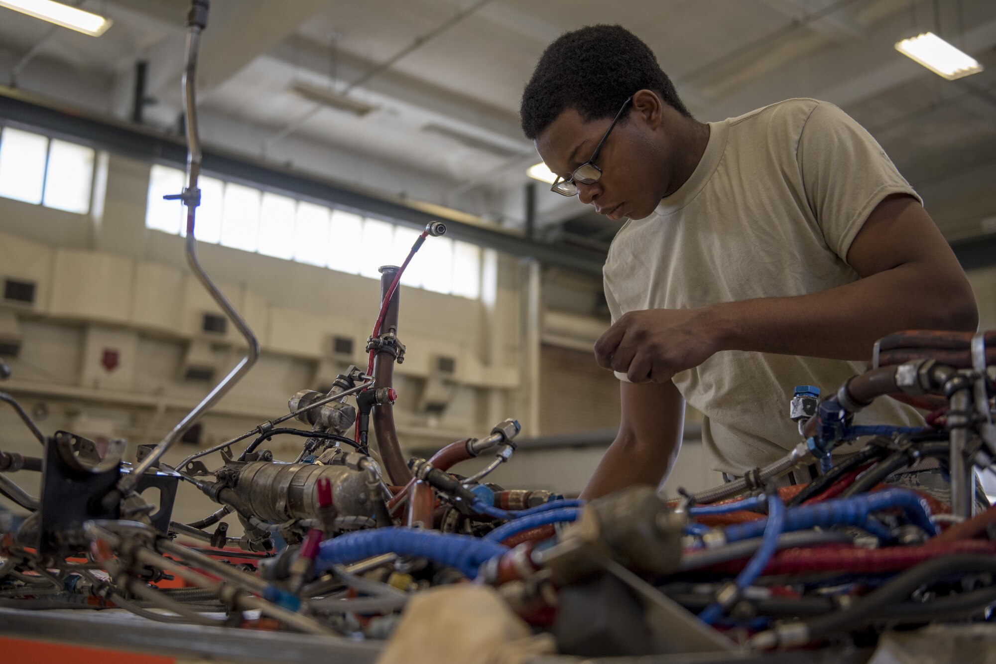 Airman 1st Class Fredrick Merritt, 18th Component Maintenance Squadron aerospace propulsion apprentice, inspects the electric harness of a TF-34 engine July 6, 2017, at Kadena Air Base, Japan. Merritt’s shop reconstructs the engines for the 25th Fighter Squadron located in Osan Air Base, Republic of Korea. (U.S. Air Force photo by Senior Airman John Linzmeier)