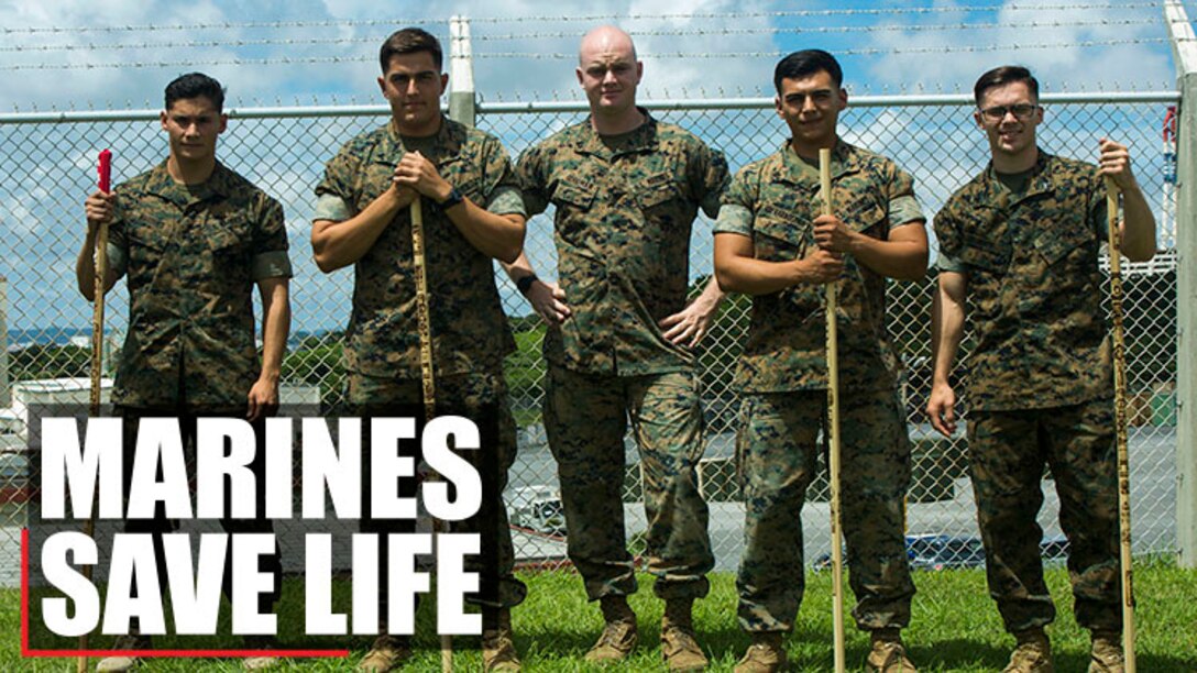 U.S. Marine Cpls. Otto Thiele (center left), Eric Goodman (center), and Christopher Ehms (far right) and Lance Cpls. Antonio Martinez (far left) and Avelardo Guevara Osuna (center right) came together to assist a local Japanese woman during their hike on Mount Fuji, Japan, July 3, 2017. The woman, Oda, was found lying on the ground, hyperventilating and struggling to breathe when the Marines came to her assistance. Together, they created a makeshift stretcher to carry her down approximately two miles to get to medical assistance. The Marines are with Electronics Maintenance Company, 3d Maintenance Battalion, Combat Logistics Regiment 35, 3d Marine Logistics Group, III Marine Expeditionary Force.