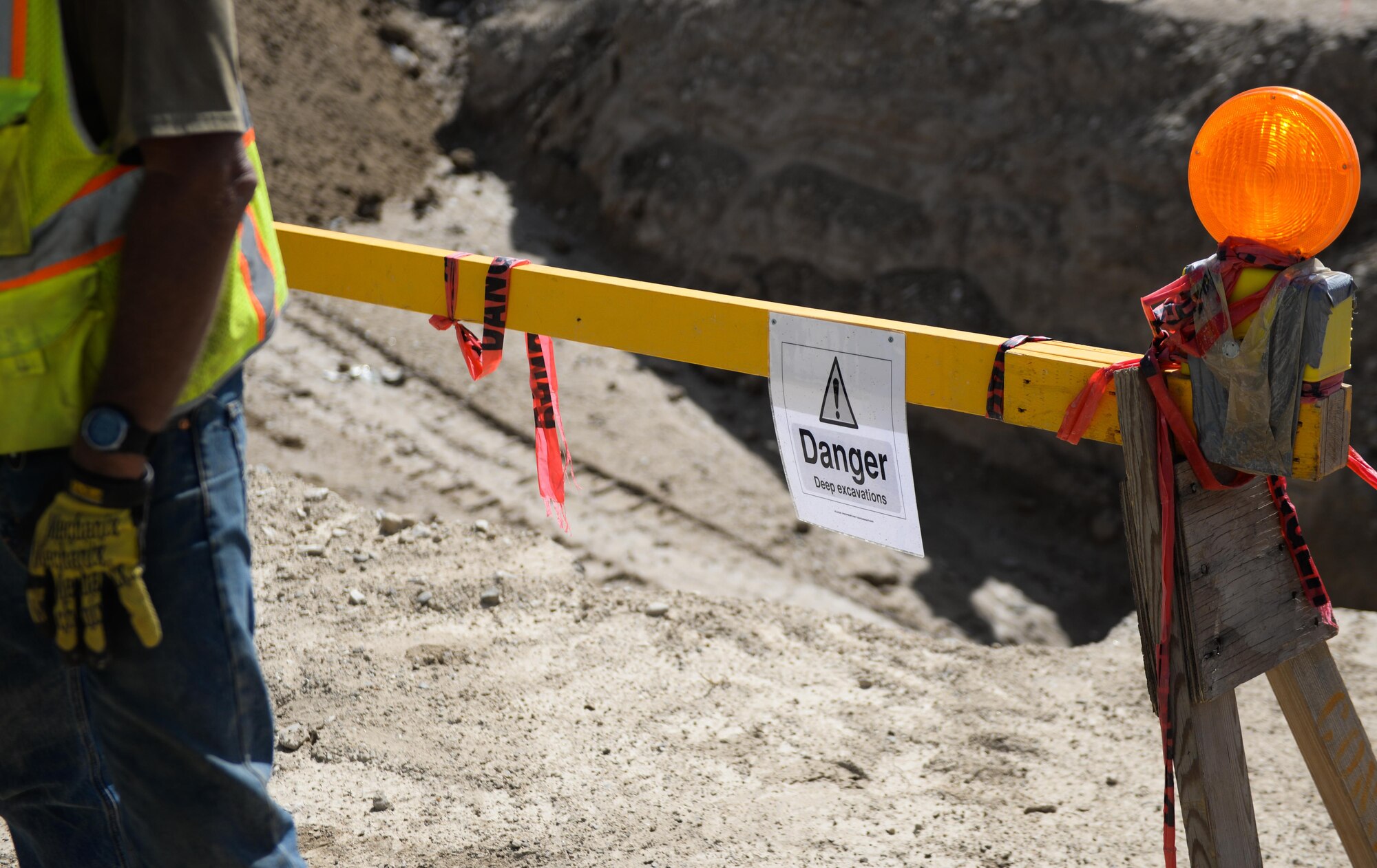 A sign marks an excavation area on Bagram Airfield, Afghanistan. Contractors at BAF are currently placing new waterlines. The 455th Air Expeditionary Wing Safety Office teamed up with the contractors and the 455th Expeditionary Civil Engineer Squadron to review safety measures and techniques for an such an environment. The event ensured U.S Airmen could meet the safety challenges of underground construction projects. (U.S. Air Force photo by Capt. Keenan Kunst)