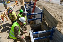 Airmen from the 455th Expeditionary Civil Engineer Squadron peer into a trench that marks the future location of a water line. The Airmen reviewed trench safety procedures with the help of the 455th Air Expeditionary Wing Safety office and contracted construction workers and engineers. These type of projects present numerous dangers for workers to be aware of; Airmen were able to learn about the hazards and how to safeguard against them. (U.S. Air Force photo by Capt. Keenan Kunst)