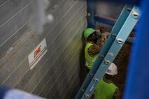 Airmen from the 455th Expeditionary Civil Engineer Squadron examine a trench at Bagram Airfield, Afghanistan. The trench, dug by contractors, will eventually contain a new water line. ECES Airmen toured the worksite to learn about the safety practices that such work requires. The visit coincided with the U.S Department of Labor's Trench Safety stand-down week. The fatality rate for excavation work is 112% higher than normal construction work, so safety is vital. (U.S. Air Force photo by Capt. Keenan Kunst)