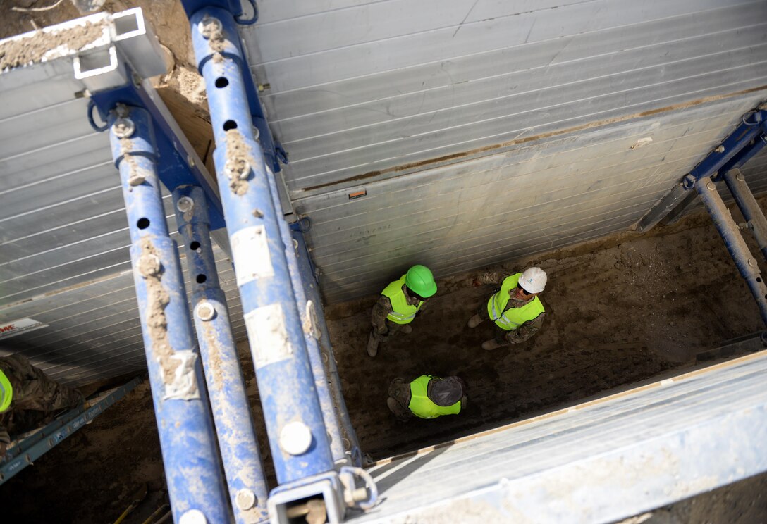 Airmen from the 455th Expeditionary Civil Engineer Squadron discuss trench and excavation work during a visit to a contractor's work site. The Airmen visited the waterline trench site, alongside the 455th Air Expeditionary Wing Occupational Safety manager, to learn about the hazards of such work, as part of the Trench Safety Stand-down week. Preventable incidents in trench work often lead to fatalities--at a rate much higher than in similar construction projects. (U.S. Air Force photo by Capt. Keenan Kunst)