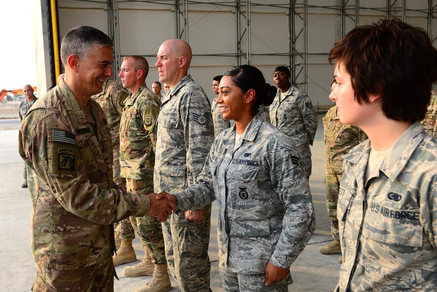 U.S. Army Lt. Gen. Stephen Townsend, Combined Joint Task Force – Operation Inherent Resolve commanding general, coins Senior Airman Gracie Martinez a security forces member assigned to the 407th Expeditionary Security Forces Squadron, during his visit to the 407th Air Expeditionary Group in Southwest Asia July 6, 2017. The general stopped at several work centers meeting with Airmen and Marines, discussing the various missions they perform at the 407th AEG and the Special Marine Air Ground Task Force. (U.S. Air Force photo by Tech Sgt. Andy M. Kin)