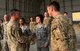 U.S. Army Lt. Gen. Stephen Townsend, Combined Joint Task Force – Operation Inherent Resolve commanding general, coins Senior Airman Olivia Faucett a fuels operator assigned to the 407th Expeditionary Logistics Readiness Squadron, during his visit to the 407th Air Expeditionary Group in Southwest Asia July 6, 2017. The general spent his visit meeting Airmen and Marines and learning about the various missions they perform at the 407th AEG and the Special Marine Air Ground Task Force. (U.S. Air Force photo by Tech Sgt. Andy M. Kin)