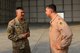 U.S. Air Force Col. John Gonzales (right) 407th Air Expeditionary Group commander, presents U.S. Army Lt. Gen. Stephen Townsend, Combined Joint Task Force – Operation Inherent Resolve commanding general, (left) with a 407th AEG coin during a visit to the 407th AEG in Southwest Asia July 6, 2017. Townsend had an all-call where he thanked Airman, Marines and coalition personnel for the great job at executing their mission in support of OIR. (U.S. Air Force photo by Tech Sgt. Andy M. Kin)