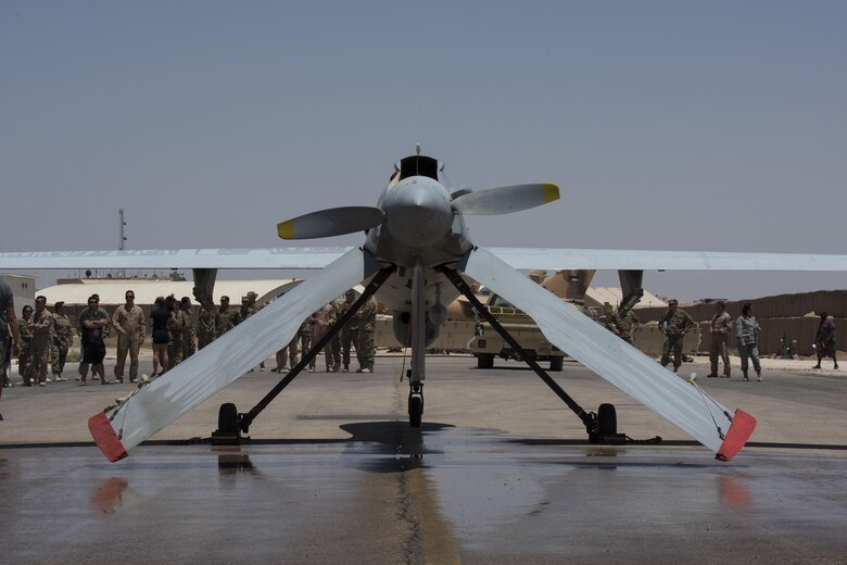 Service members and civilians gather to commemorate the last flight of a MQ-1B Predator assigned to the 361st Expeditionary Attack Squadron, July 2, 2017, in Southwest Asia. In the 18 months the MQ-1B was assigned to the 361st Expeditionary Reconnaissance Squadron, later designated as the 361st EATKS, its aircrew flew the aircraft on more than 2,000 combat missions, 36,000 persistence attack and reconnaissance hours, and fired 358 AGM-114 Hellfire missiles, greatly contributing to the fight against ISIS. (U.S. Air Force photo/Senior Airman Damon Kasberg)