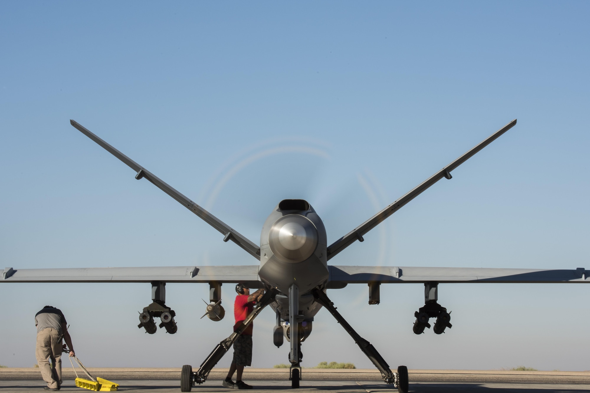 Maintainers perform final preflight procedures prior to a MQ-9 Reaper, Block 5 variant, taking off June 23, 2017, in Southwest Asia. This marked the block’s first combat flight in support of Operation Inherent Resolve. (U.S. Air Force photo/Senior Airman Damon Kasberg)