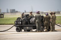U.S. Airmen from 353rd Special Operations Group and 18th Logistics Readiness Squadron work with Marines from Marine Wing Support Squadron 172 to set up a fuel truck during a forward area refueling point joint training exercise June 27, 2017, at Kadena Air Base, Japan. The two-day exercise enabled the U.S. Air Force and Marine Corps to improve interoperability and develop tactics, techniques and procedures involving the new aircraft for future joint FARP operations throughout the Indo-Asia Pacific Theater. (U.S. Air Force photo by Senior Airman Omari Bernard)