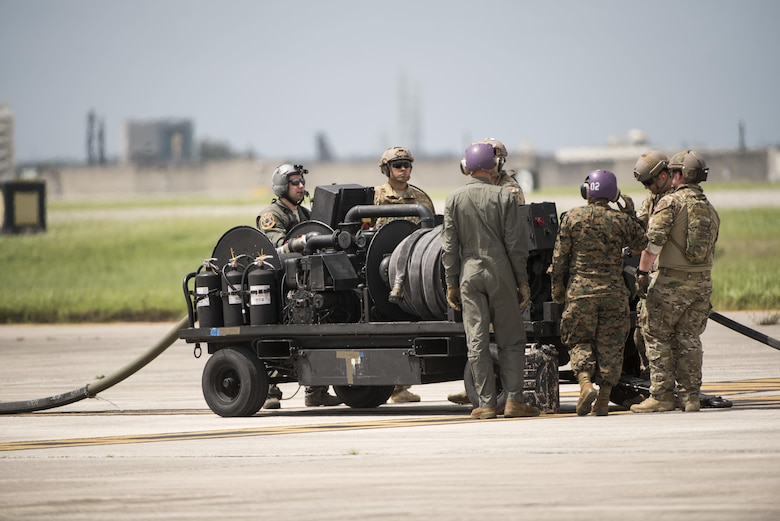 U.S. Airmen from 353rd Special Operations Group and 18th Logistics Readiness Squadron work with Marines from Marine Wing Support Squadron 172 to set up a fuel truck during a forward area refueling point joint training exercise June 27, 2017, at Kadena Air Base, Japan. The two-day exercise enabled the U.S. Air Force and Marine Corps to improve interoperability and develop tactics, techniques and procedures involving the new aircraft for future joint FARP operations throughout the Indo-Asia Pacific Theater. (U.S. Air Force photo by Senior Airman Omari Bernard)