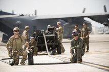 U.S. Airmen from 353rd Special Operations Group and 18th Logistics Readiness Squadron stand by with Marines from Marine Wing Support Squadron 172 to refuel an F-35B Lighting II during a forward area refueling point joint training exercise June 27, 2017, at Kadena Air Base, Japan. The short range take off capability of the 353rd Special Operations Group’s MC-130 combined with the vertical takeoff and landing capabilities of the Marine Fighter Attack Squadron 121’s F-35B Lightning II enables a fighter presence anywhere in the Pacific.  (U.S. Air Force photo by Senior Airman Omari Bernard)