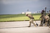 U.S. Air Force Staff Sgt. Patrick Skiles, 18th Logistics Readiness Squadron forward area refueling point team member, wrings out a refueling hose after FARP joint training exercise June 27, 2017, at Kadena Air Base, Japan. The training between services gave the Marine Corps a unique opportunity to practice joint operations with the 353rd Special Operations Group by utilizing the MC-130J Commando II and MC-130H Talon II's unique ability to air deliver 18th Logistics Squadron ground refueling operations to forward deployed locations. (U.S. Air Force photo by Senior Airman Omari Bernard)