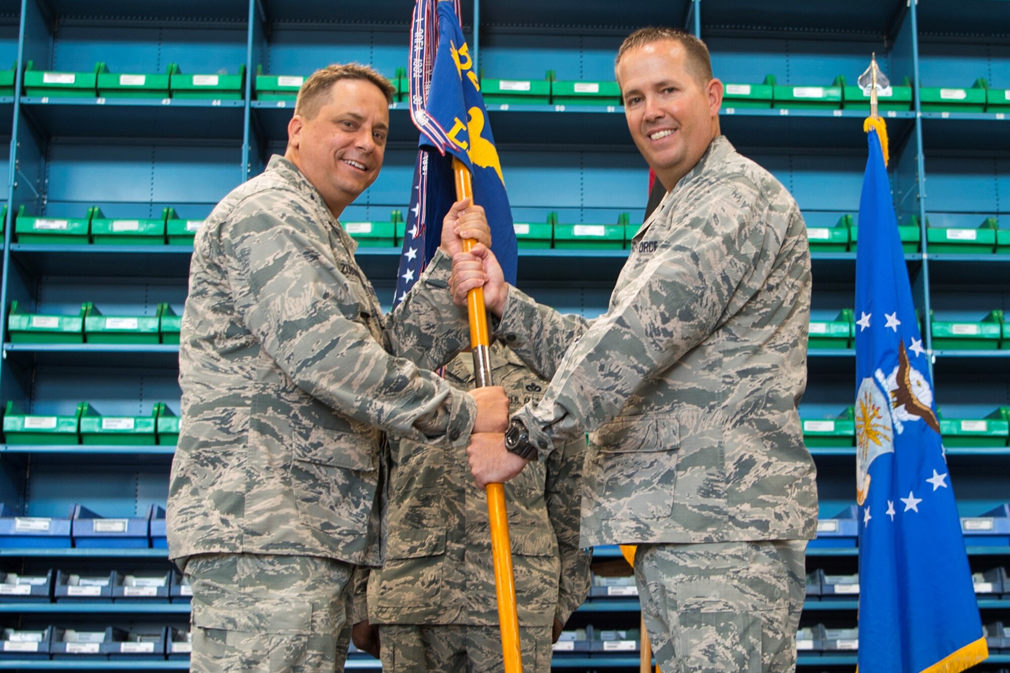U.S. Air Force Col. Steven Zubowicz, 52nd Mission Support Group commander, left, gives the ceremonial guidon to U.S. Air Force Lt. Col. Timothy Foster, incoming 52nd Logistics Readiness Squadron commander, right, during the 52nd LRS change of command ceremony at Spangdahlem Air Base, Germany, July 7, 2017. (U.S. Air Force photo by Senior Airman Dawn Weber)