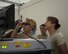 U.S. Air Force Airmen with the 8th Expeditionary Air Mobility Squadron scrutinize baggage for prohibited items on a monitor at a luggage screening check point at Al Udeid Air Base, Qatar, June 14, 2017. The airmen are enhancing their knowledge on safety precautions for inspection of personnel luggage as they go through the passenger terminal. (U.S. Air Force photo by Tech. Sgt. Amy M. Lovgren)