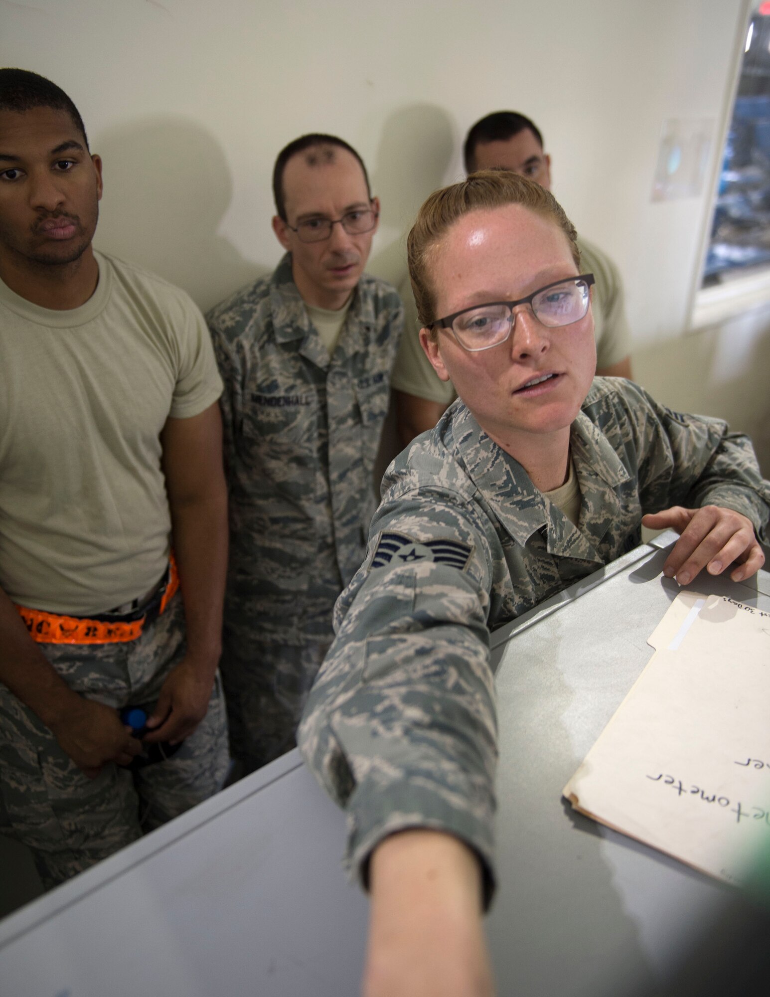 U.S. Air Force Staff Sgt. Courtnee Hummel, a passenger service agent with the 8th Expeditionary Air Mobility Squadron screens objects on the monitor at Al Udeid Air Base, Qatar, June 14, 2017. Hummel is helping her fellow airmen test their knowledge on the latest safety precautions for inspecting personnel luggage as they go through the passenger terminal. (U.S. Air Force photo by Tech. Sgt. Amy M. Lovgren)
