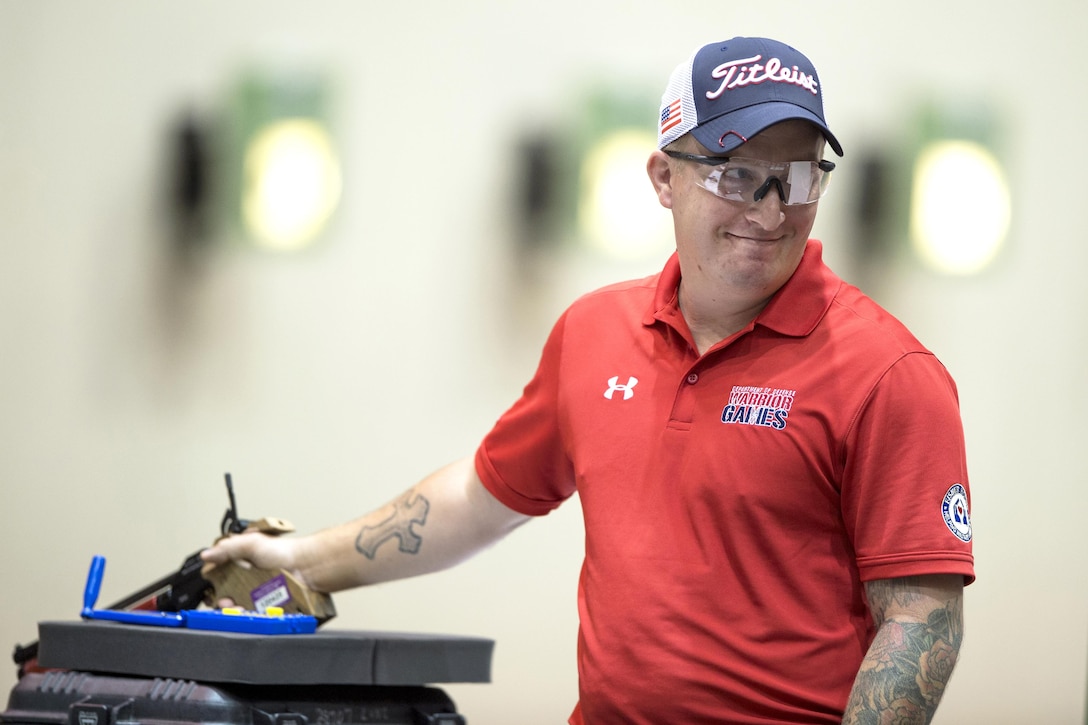 Marine Corps Sgt. Jacob Greenlief reacts to his winning shot for gold in the open category of pistol shooting during the 2017 Department of Defense Warrior Games in Chicago, July 6, 2017. The Warrior Games are an annual event allowing wounded, ill and injured service members and veterans to compete in Paralympic-style sports. DoD photo by EJ Hersom