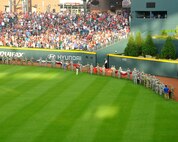 A group of about 80 men and women from the Army, Georgia National Guard, Air National Guard and Air Force Reserve line up holding an enormous United States-shaped American Flag at SunTrust Park in Atlanta, Georgia. The group volunteered to unfurl the flag during the opening ceremony of the Atlanta Braves game on July 4, 2017. (U.S. Air Force photo by Staff Sgt. Jaimi L. Upthegrove)