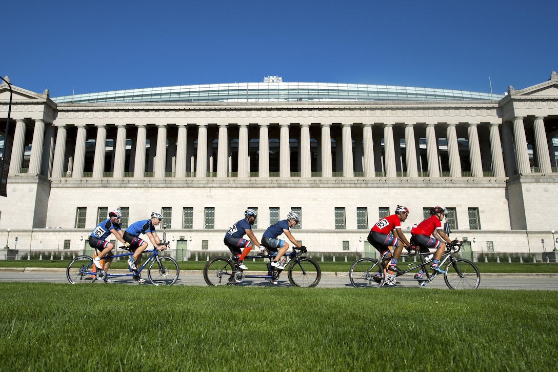 Visually impaired riders race with their guiding drivers in front of the Soldier Field facade along Museum Campus Drive in Chicago during the 2017 Department of Dense Warrior Games July 6, 2017. The DoD Warrior Games are an annual event allowing wounded, ill and injured service members and veterans to compete in Paralympic-style sports. DoD photo by EJ Hersom