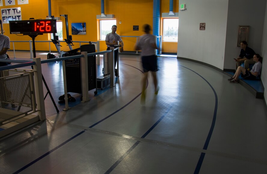 Senior Airman Courtney Sire, Fitness Assessment Cell physical training leader, counts testing Airmen’s laps during a fitness assessment at the McAdoo Fitness Center on Minot Air Force Base, N.D., June 28, 2017. The FAC Airmen’s duties include measuring weight, height and abdominal circumference as well as timing pushups, situps, a 1.5 mile run and a two mile walk. (U.S. Air Force photo by Airman 1st Class Alyssa M. Akers)