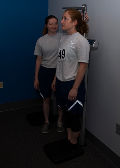 Senior Airman Courtney Sire, Fitness Assessment Cell physical training leader, measures an Airman’s height during a fitness assessment at the McAdoo Fitness Center on Minot Air Force Base, N.D., June 29, 2017. These FAC Airmen are responsible for administering all fitness assessments and schedule no fewer than 50 tests a month. (U.S. Air Force photo by Airman 1st Class Alyssa M. Akers)