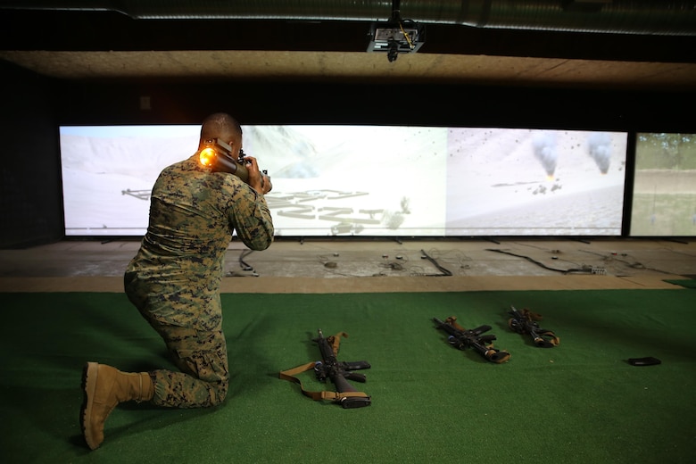 Master Sgt. Jorge Carrillo, staff non-commissioned officer-in-charge at Marksmanship Training Battalion aboard Marine Corps Base Quantico, Virginia, fires an M72 Light Anti-Tank Weapon, one of the new additions to the Indoor Simulated Marksmanship Trainer III. The ISMT III adds three new weapons, 3-D imagery, and enhanced training modes, giving Marines a better, more realistic training experience as they prepare for the complexities of modern warfare. (U.S. Marine Corps photo by Ashley Calingo) [High-resolution photo]