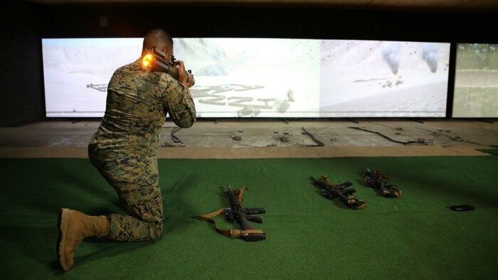 Master Sgt. Jorge Carrillo, staff non-commissioned officer-in-charge at Marksmanship Training Battalion aboard Marine Corps Base Quantico, Virginia, fires an M72 Light Anti-Tank Weapon, one of the new additions to the Indoor Simulated Marksmanship Trainer III. The ISMT III adds three new weapons, 3-D imagery, and enhanced training modes, giving Marines a better, more realistic training experience as they prepare for the complexities of modern warfare. (U.S. Marine Corps photo by Ashley Calingo) 