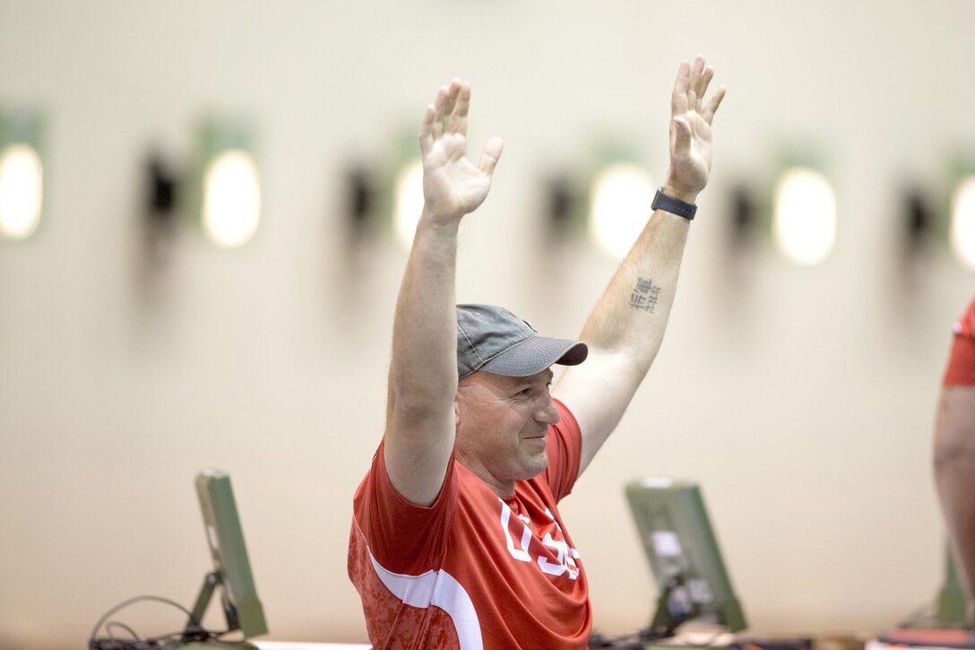 Marine Corps Gunnery Sgt. Godfrey Douglas reacts to winning gold in the SH1 category of pistol shooting of the 2017 Department of Defense Warrior Games in Chicago, July 6, 2017. The DoD Warrior Games allow wounded, ill and injured service members and veterans to compete in Paralympic-style sports. DoD photo by EJ Hersom