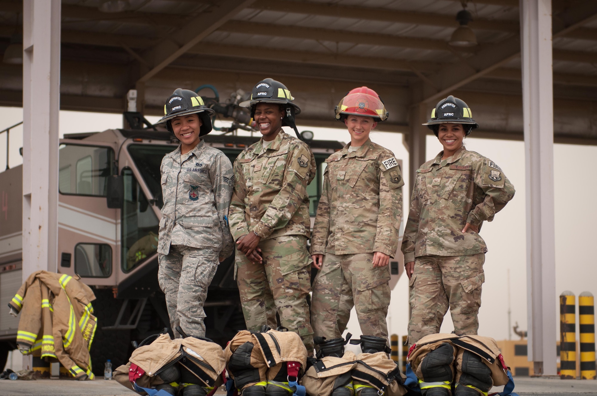 From left to right, Senior Airman Ayanna Gaskin, Senior Airman Christa Dennis, Senior Airman Ashley Eisenbart, and Staff Sgt. Jessica Mendoza, firefighters assigned to the 386th Civil Engineer Squadron, pose for a photo in front of a fire truck at the fire station June 25, 2017, an undisclosed location in Southwest Asia. (U.S. Air Force photo by Master Sgt. Eric M. Sharman)