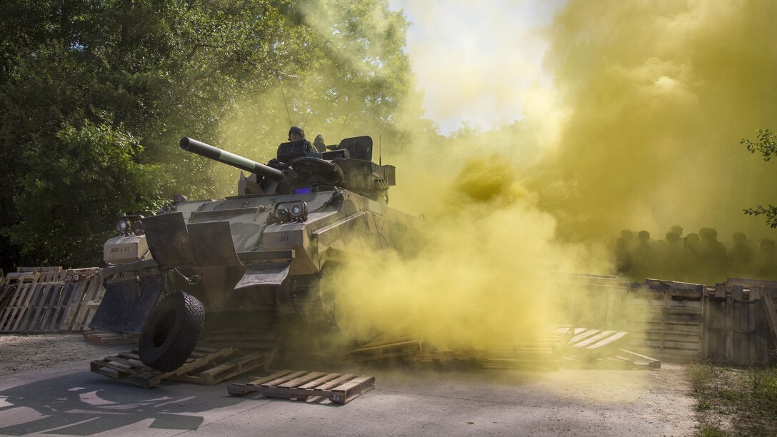 Soldiers breach a barricade with an M113 opposing forces surrogate vehicle/main battle tank during a riot control training scenario as part of a mission rehearsal exercise at the Joint Multinational Readiness Center in Hohenfels, Germany, July 6, 2017. The soldiers are assigned to the 82nd Airborne Division’s 3rd Battalion, 319th Field Artillery Regiment. Army photo by Spc. Randy Wren
