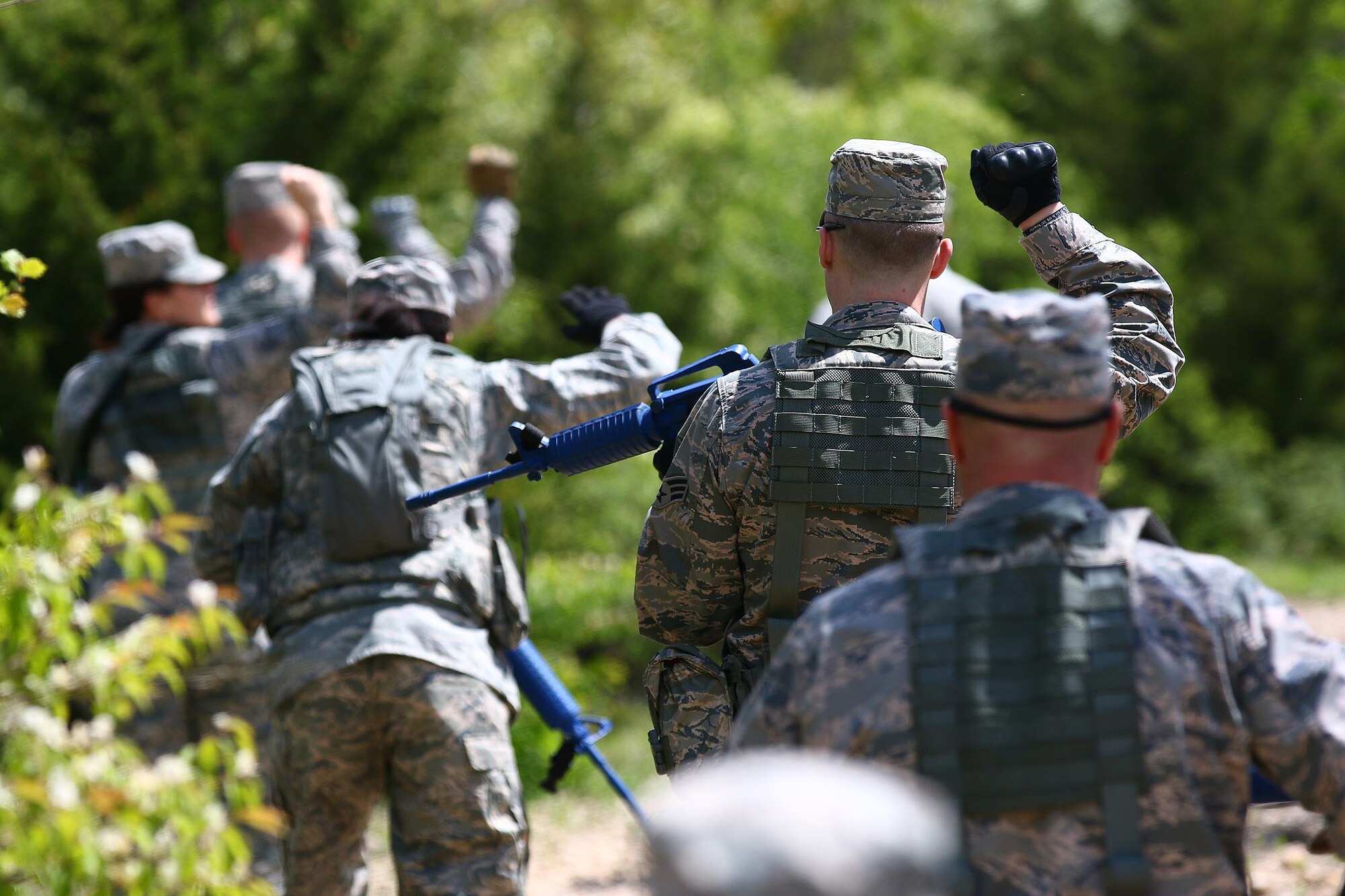 Members of the 445th Security Forces Squadron execute hand signals during ‘dismount’ training at the Oakes Quarry Park, Fairborn, Ohio May 6, 2017. The three-day expeditionary training consisted of several phases to include: Humvee mount/dismount, SERE, setting up/tear down tents, and night vision goggles. (U.S. Air Force photo /Tech. Sgt. Patrick O’Reilly)