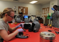 Members of the 5th Operations Support Squadron aircrew flight equipment helmet section assemble and inspect helmets at Minot Air Force Base, N.D., June 29, 2017. These technicians ensure helmets and oxygen masks are cleaned, inspected and assembled correctly. (U.S. Air Force Photo by Airman 1st Class Jessica Weissman)