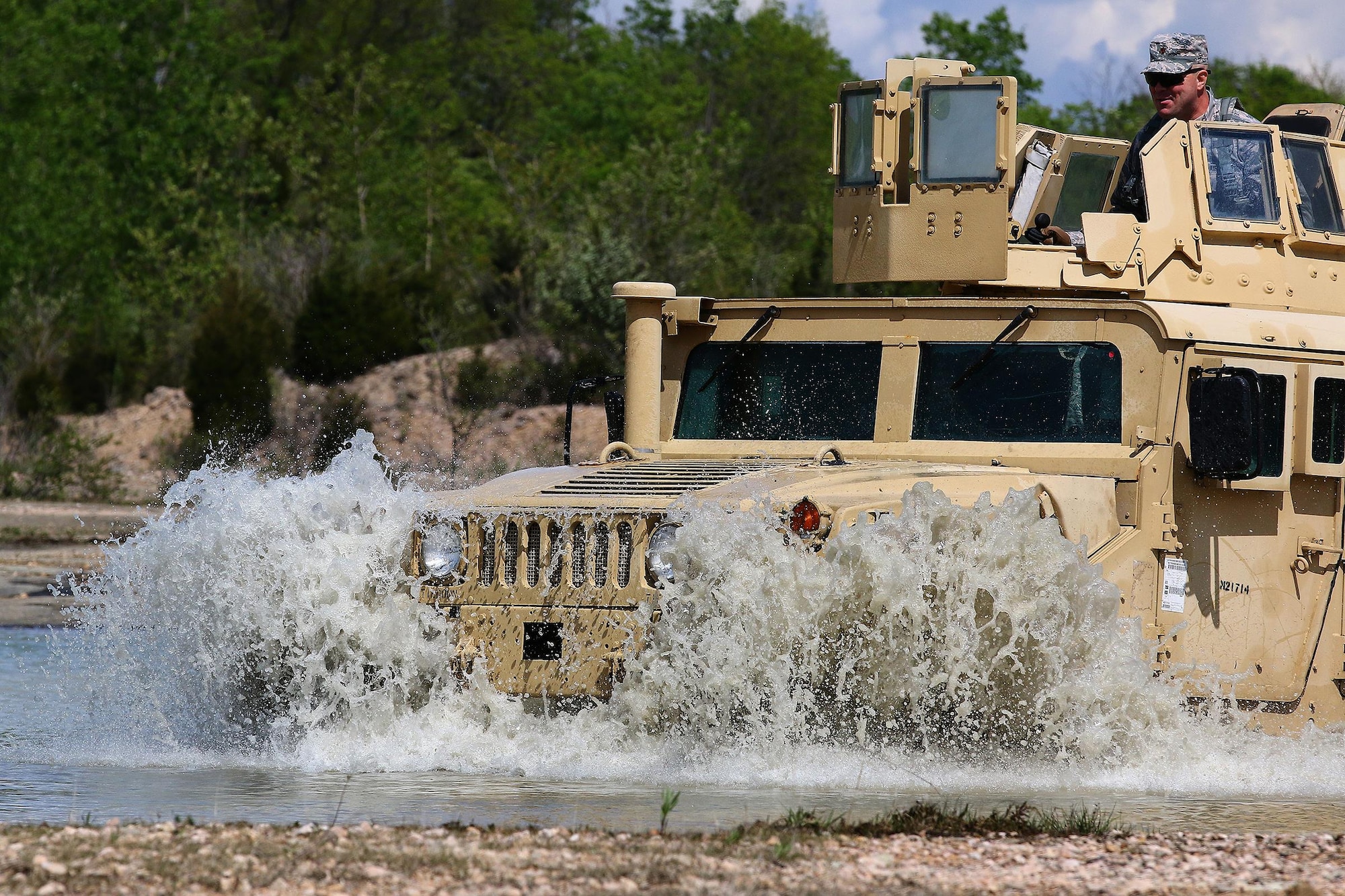 Airmen from the 445th Security Forces Squadron drive a Humvee through rugged terrain for training at the Oakes Quarry Park, Fairborn, Ohio May 6, 2017. The three-day expeditionary training consisted of several phases to include: Humvee mount/dismount, SERE, setting up/tear down tents, and night vision goggles. (U.S. Air Force photo /Tech. Sgt. Patrick O’Reilly)