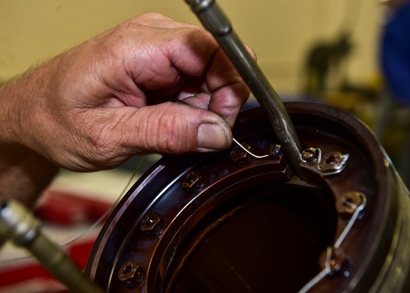 Master Sgt. Ben Sewall, an aerospace propulsion craftsman from the 910th Maintenance Squadron here, applies safety wire to a C-130H engine turbine July 6, 2017. The safety wire ensures that the installed bolts resist the vibrations of the turbine and remain in place during flight. (U.S. Air Force Photo/Senior Airman Jeffrey Grossi)