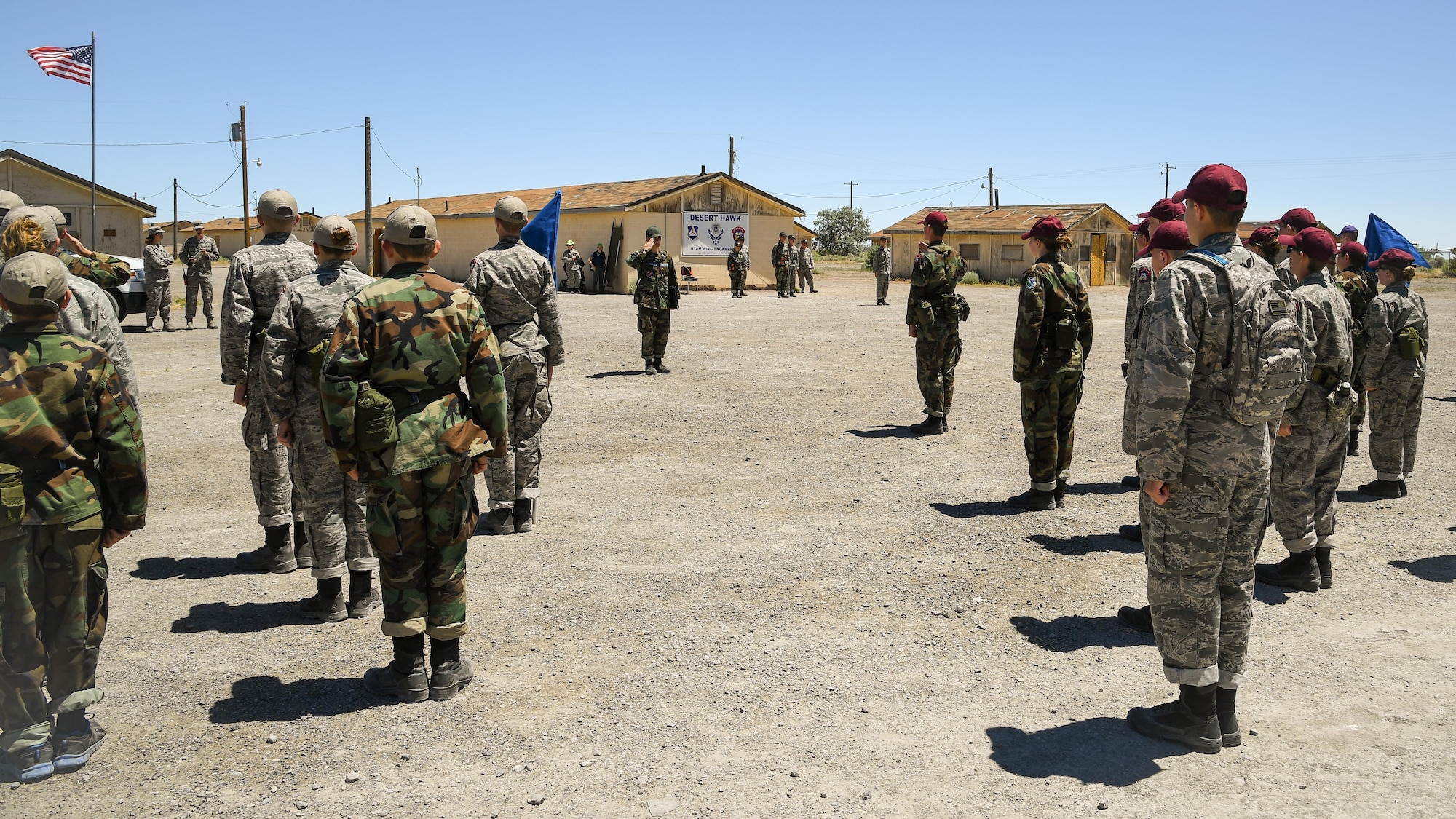 Civil Air Patrol Cadets stand in formation before performing a pass in review march during the Desert Hawk XV encampment, Wendover Historic Air Field, Utah, June 22, 2017. (U.S. Air Force photo/R. Nial Bradshaw)