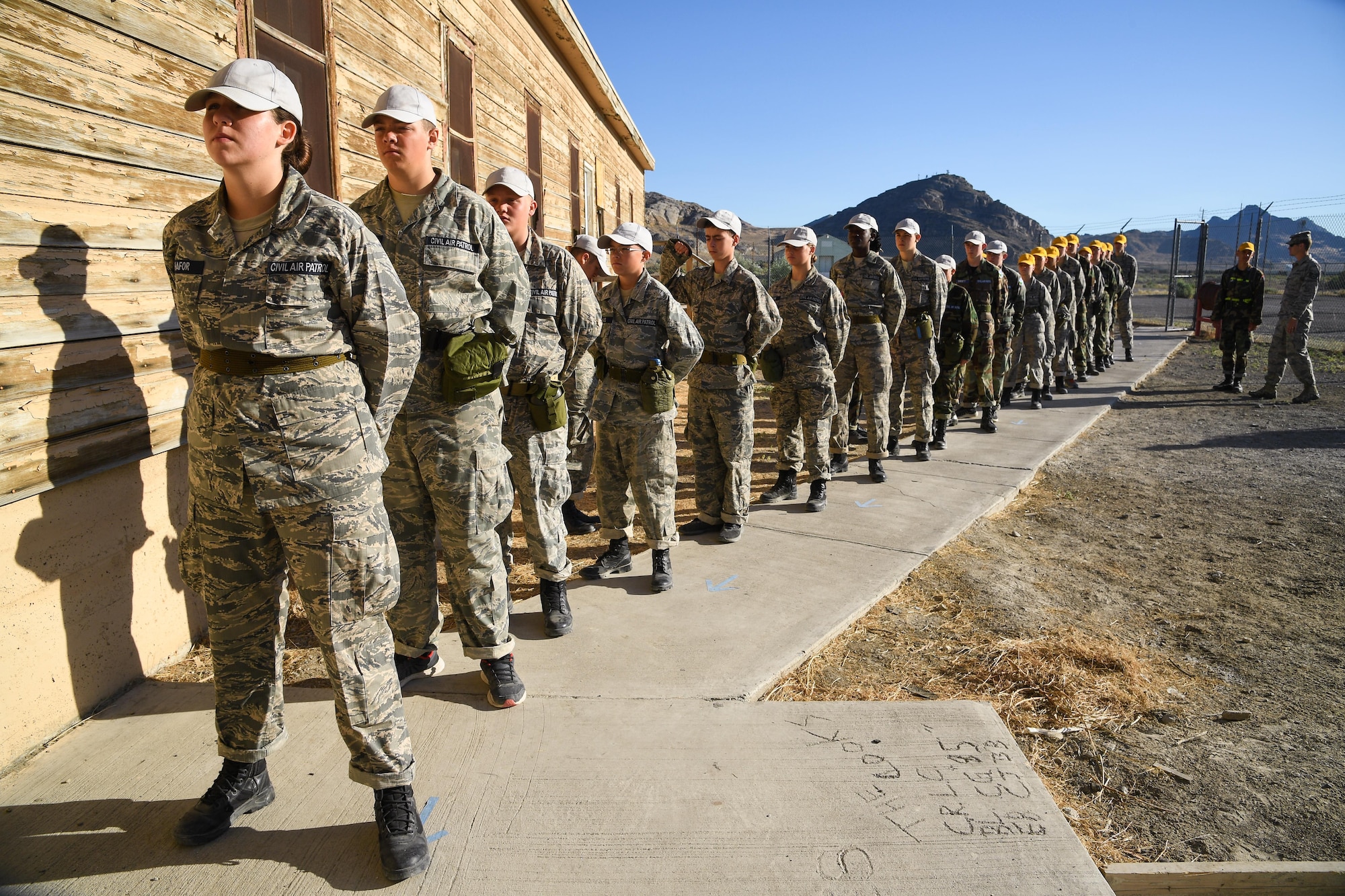 Civil Air Patrol Cadets line up outside the chow hall before breakfast during the week-long Desert Hawk XV training encampment, Wendover Historic Airfield, Wendover, Utah, June 22, 2017. (U.S. Air Force photo/R. Nial Bradshaw)
