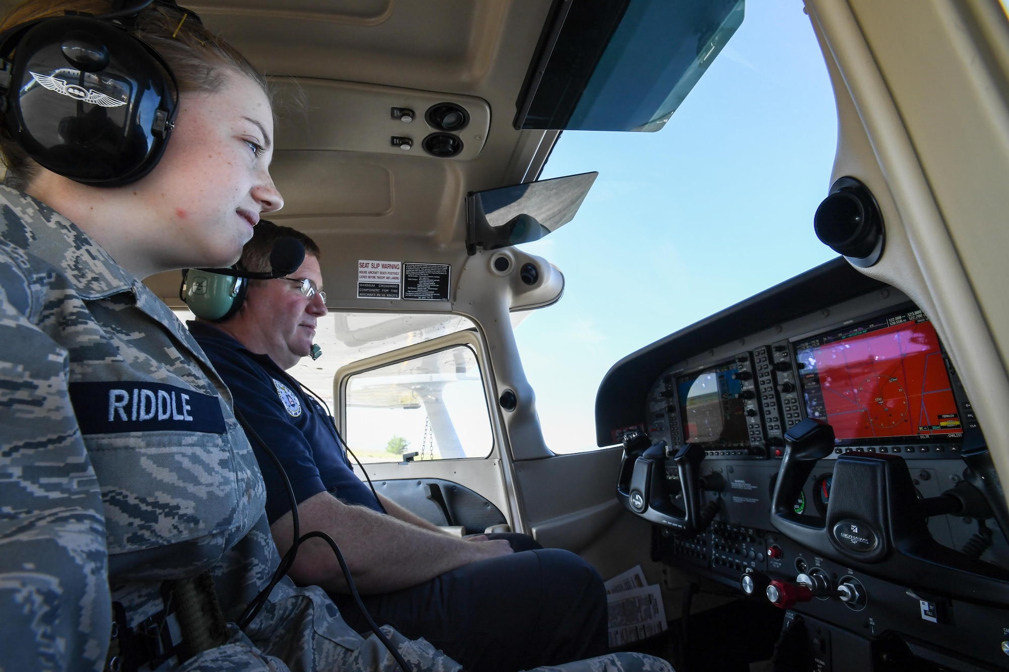 A Civil Air Patrol Cadet and pilot, Maj. Lance Helsten, sit in a Cessna aircraft prior to an orientation flight, Wendover Historic Airfield, Utah, June 22, 2017. (U.S. Air Force photo/R. Nial Bradshaw)