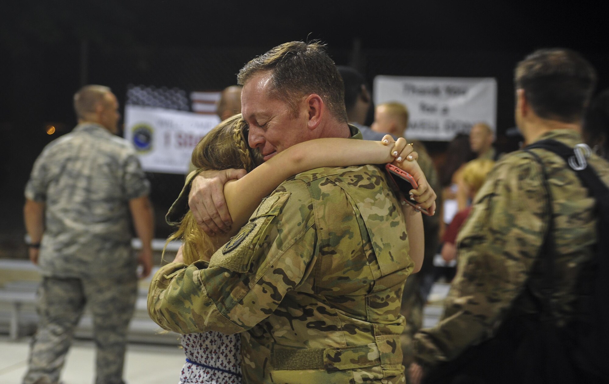 Maj. Scott Reinecke, an AC-130W evaluator pilot with Headquarters Air Force Special Operations Command, hugs his daughter during Operation Homecoming at Hurlburt Field, Fla., July 5, 2017. Operation Homecoming welcomes home Air Commandos from their overseas deployment. (U.S. Air Force photo by Airman 1st Class Isaac O. Guest IV)