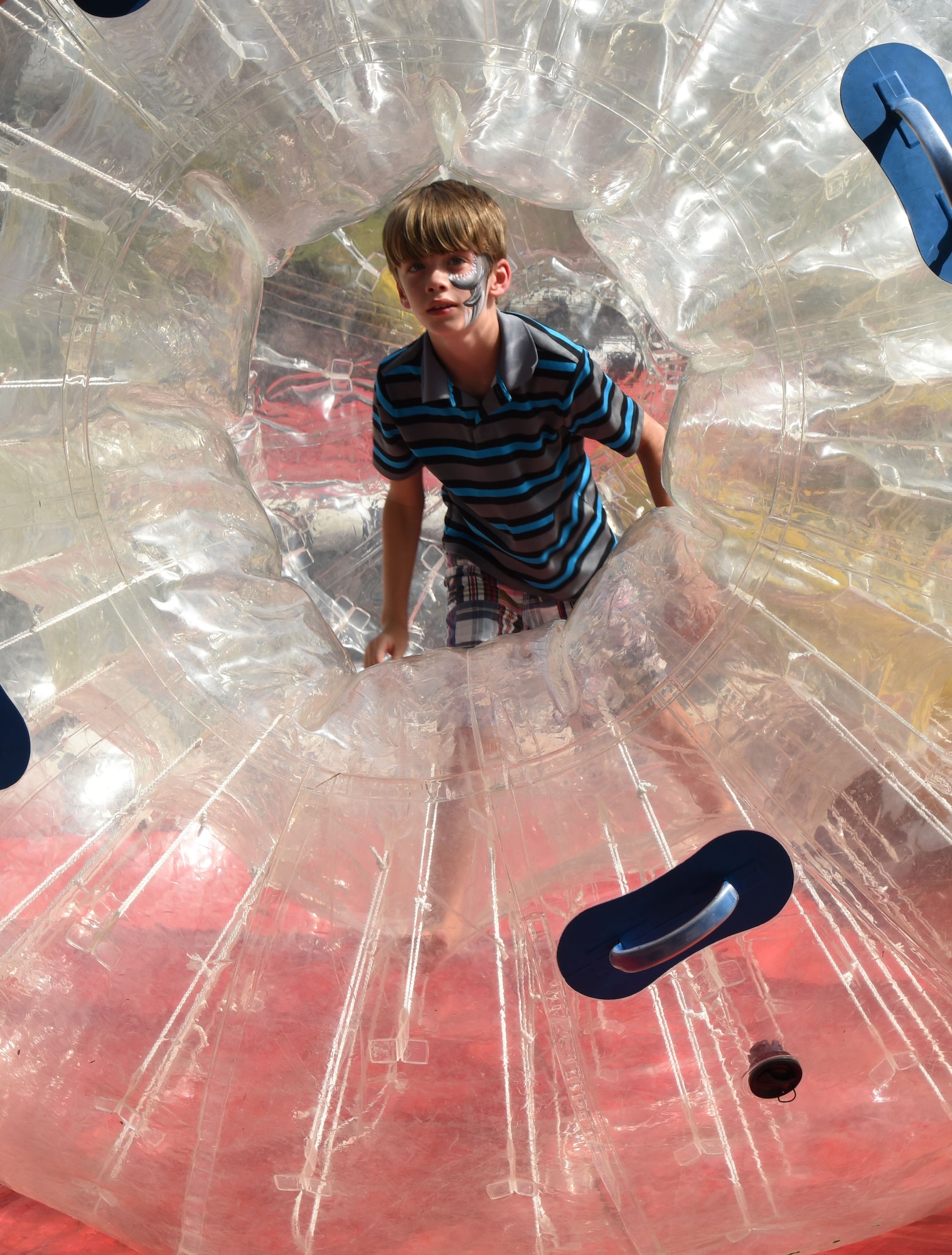 Chris Sentilles , son of Master Sgt. Chris Sentilles, 815th Airlift Squadron load master, plays inside a hamster ball during the Pops in the Park event at Marina Park July 1, 2017, on Keesler Air Force Base, Miss. The event also included a kids’ fishing rodeo, mullet toss, fireworks display and music performances. (U.S. Air Force photo by Kemberly Groue)