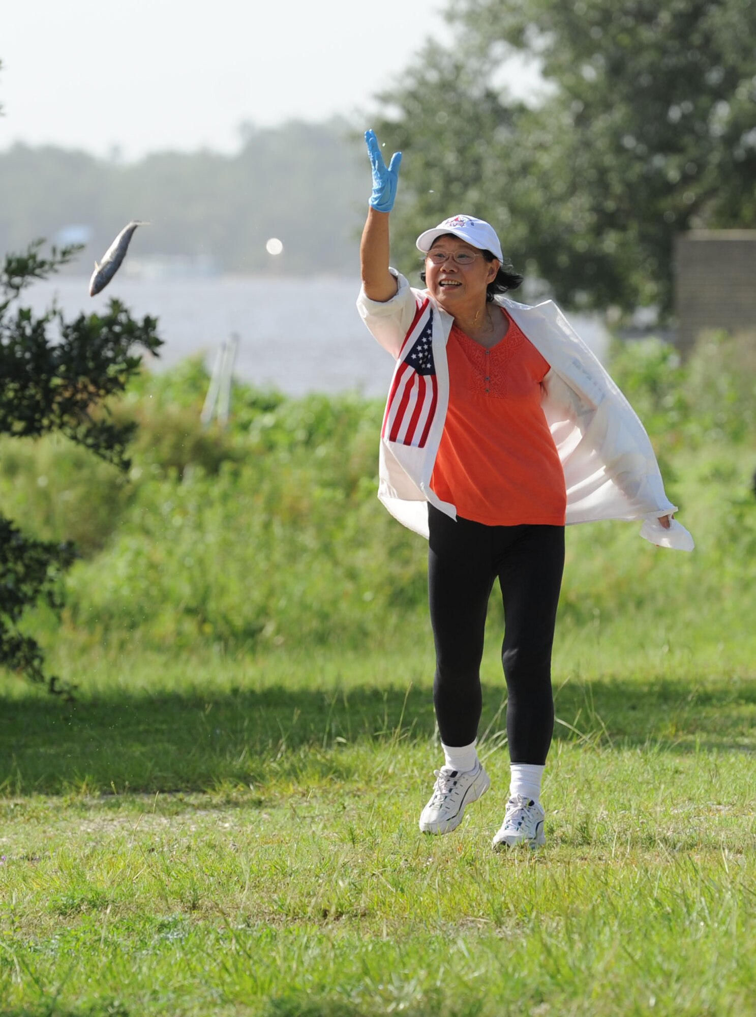 Sin Tzu Lovette, mother of Col. Debra Lovette, 81st Training Wing commander, tosses a mullet during the mullet toss competition during the Pops in the Park event at Marina Park July 1, 2017, on Keesler Air Force Base, Miss. The event also included a kids’ fishing rodeo, fireworks display and music performances. (U.S. Air Force photo by Kemberly Groue)