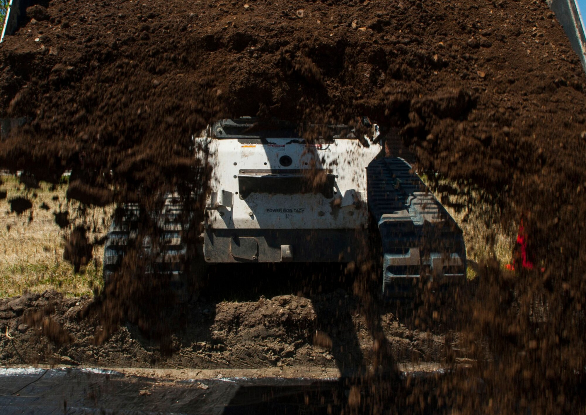 Airman 1st Class Harold McIntyre, 5th Civil Engineer Squadron pavements and equipment technician, fills a sidewalk trench at Minot Air Force Base, N.D., June 12, 2017. Due to cracks and general wear and tear in the sidewalks, the 5 CES “Dirt Boys” worked several hours to repair them. (U.S. Air Force photo by Airman 1st Class Jonathan McElderry)