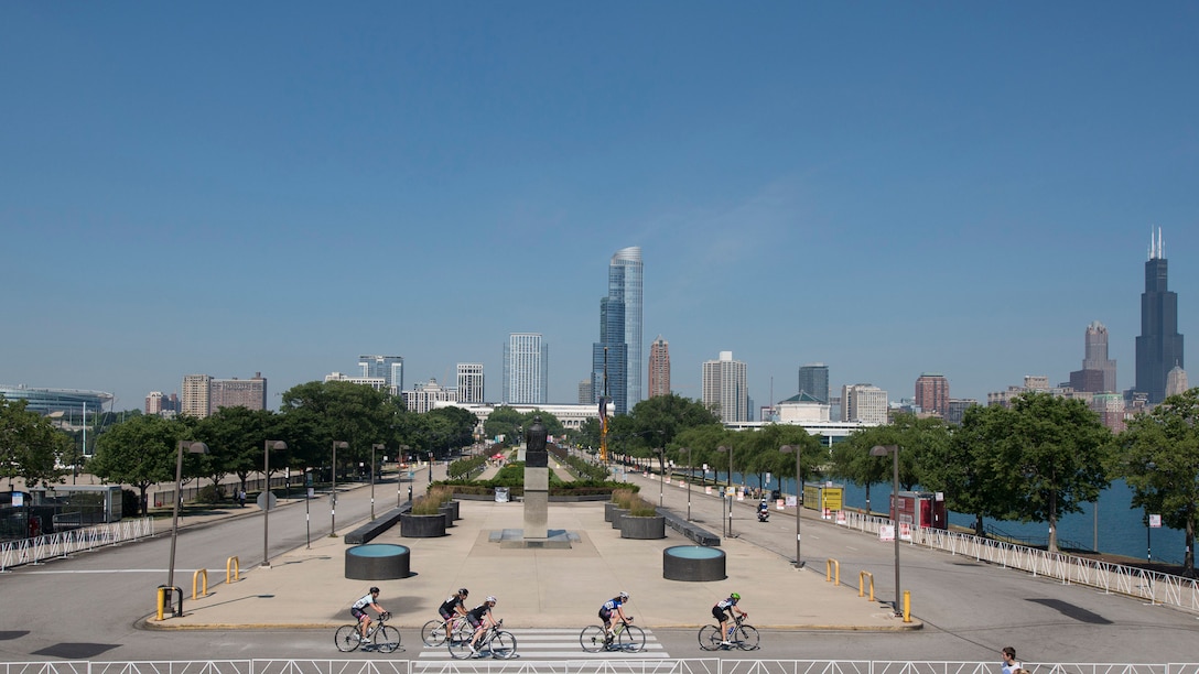 Athletes ride past Adler Planetarium during the cycling competition for the 2017 Department of Defense Warrior Games in Chicago, Ill., July 6, 2017. The annual games allow wounded, ill and injured service members and veterans to compete in paralympic-style sports including archery, cycling, field, shooting, sitting volleyball, swimming, track and wheelchair basketball. DoD photo by Roger L. Wollenberg