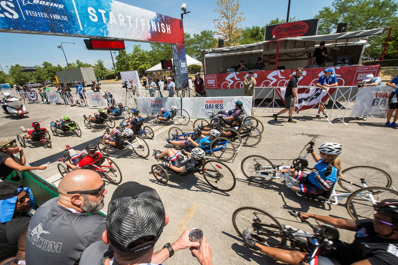 Athletes ride past Adler Planetarium during the cycling competition for the 2017 Department of Defense Warrior Games in Chicago, Ill., July 6, 2017. The games are an annual event allowing wounded, ill and injured service members and veterans to compete in paralympic-style sports. DoD photo by Roger L. Wollenberg