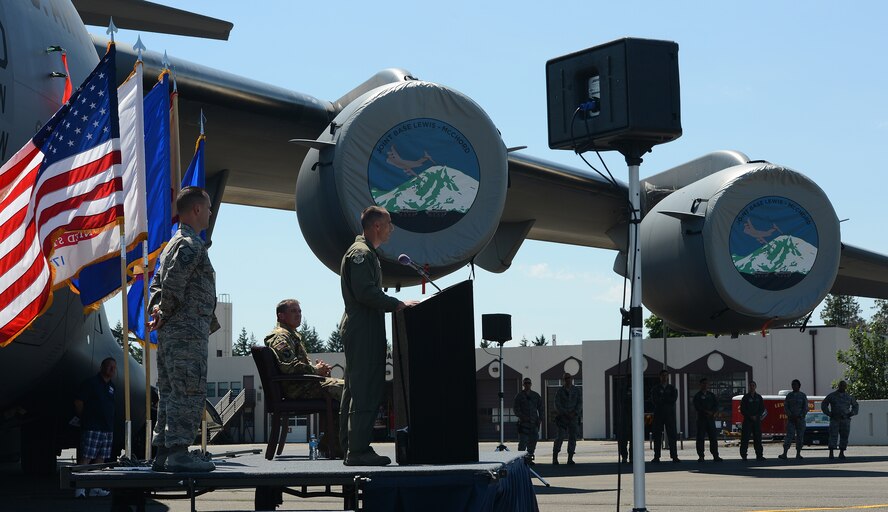 Col. Leonard Kosinski, 62nd Airlift Wing commander, speaks about joint basing at a C-17 Globemaster III naming ceremony July 5, 2017, at Joint Base Lewis McChord, Wash. The naming of the aircraft was to commemorate McChord Field and Fort Lewis joint basing efforts and the efforts of Airmen and Soldiers as joint warfighters. (U.S. Air Force photo/Senior Airman Jacob Jimenez) 