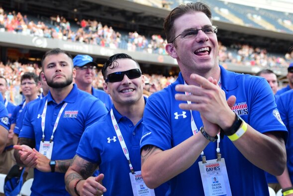 Air Force Staff Sgt. David Olson, an explosive ordnance disposal troop from Abilene, TX, cheers enthusiastically as the Air Force is introduced at the 2017 Department of Defense Warrior Games opening ceremony July 1, 2017, at Soldier Field, Chicago, Ill. While it has been a short seven-month journey for Olson toward recovery, he recalls how dark of a place he was previously in compared to now, noting the measurable distance he is today from who he was then. (U.S. Air Force photo/Staff Sgt. Alexx Pons) 